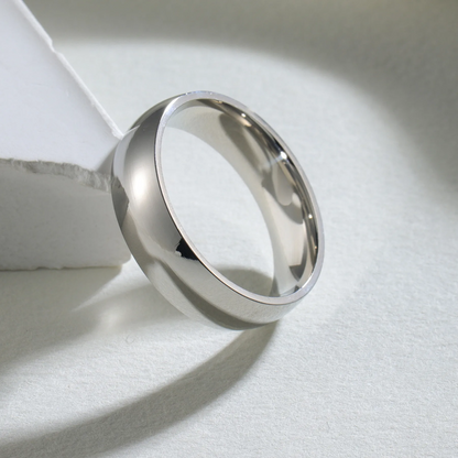 Silver ring on a white fabric background