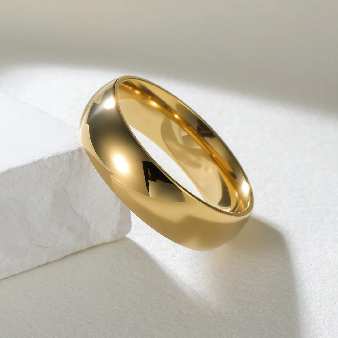 Gold ring with a black letter 'A' on a white background