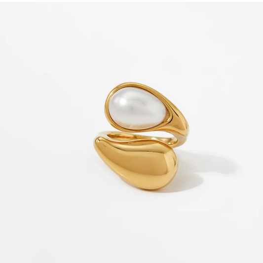 Gold ring with a pearl on a white background