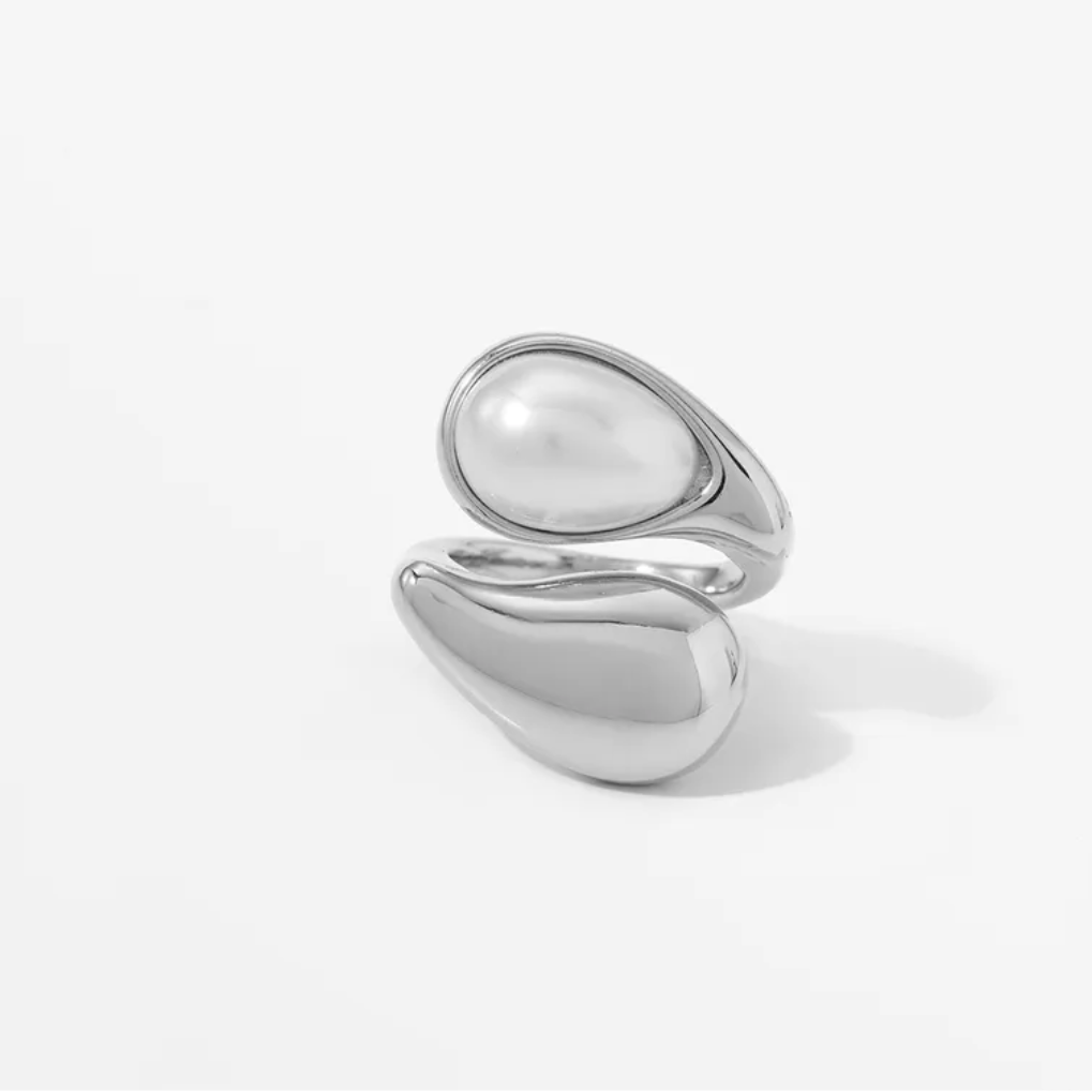 Silver ring with a unique design on a white background