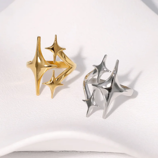 Gold and silver geometric star-shaped earrings on a white background