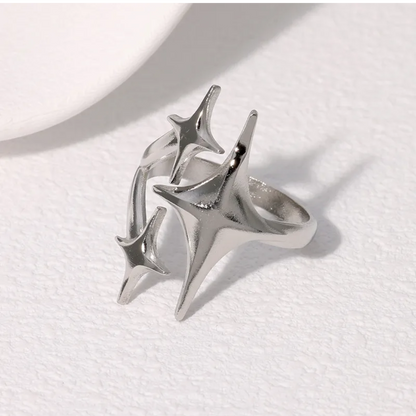 Silver ring with star-like design on a white background