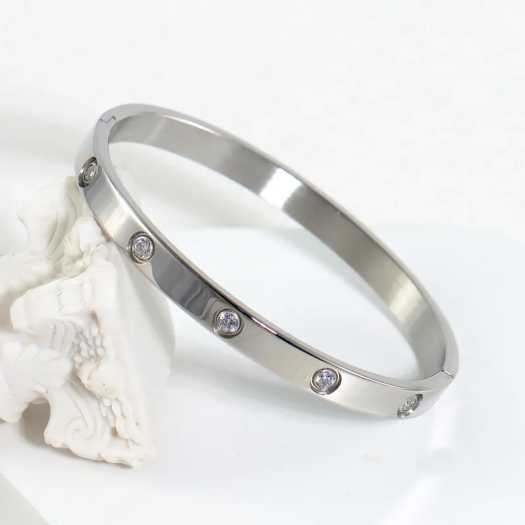 Silver bracelet with small stones on a white background