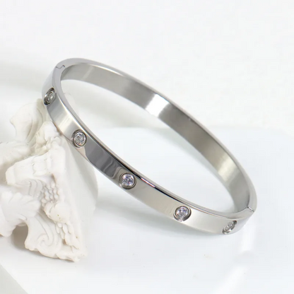 Silver bracelet with small stones on a white background