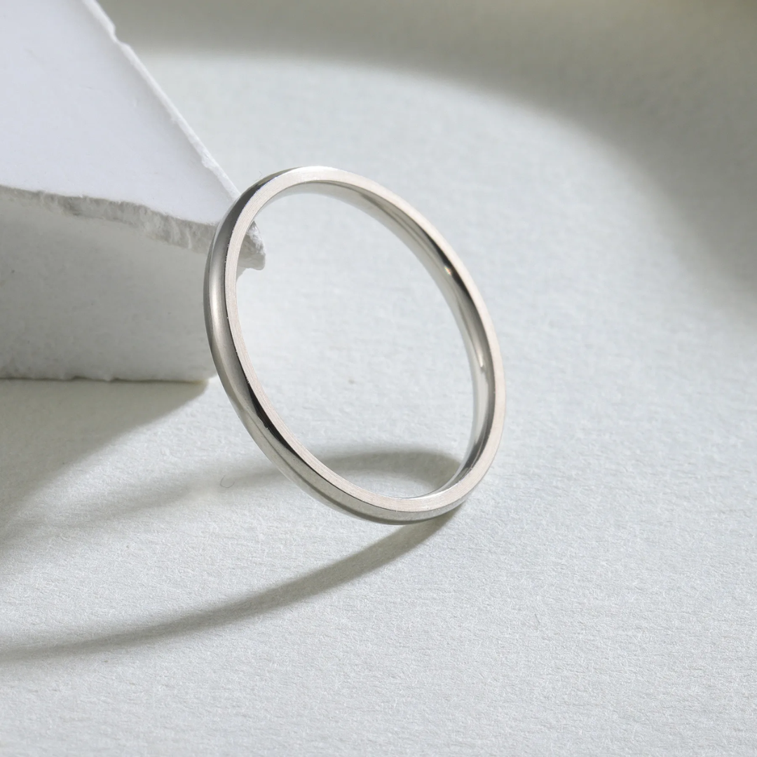 Silver ring on a light gray surface