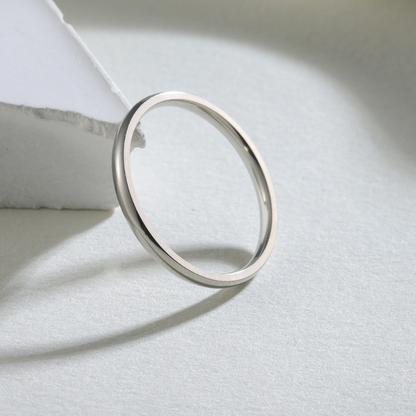 Silver ring on a light gray surface