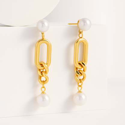 Gold chain earrings with pearl-like beads on a white background