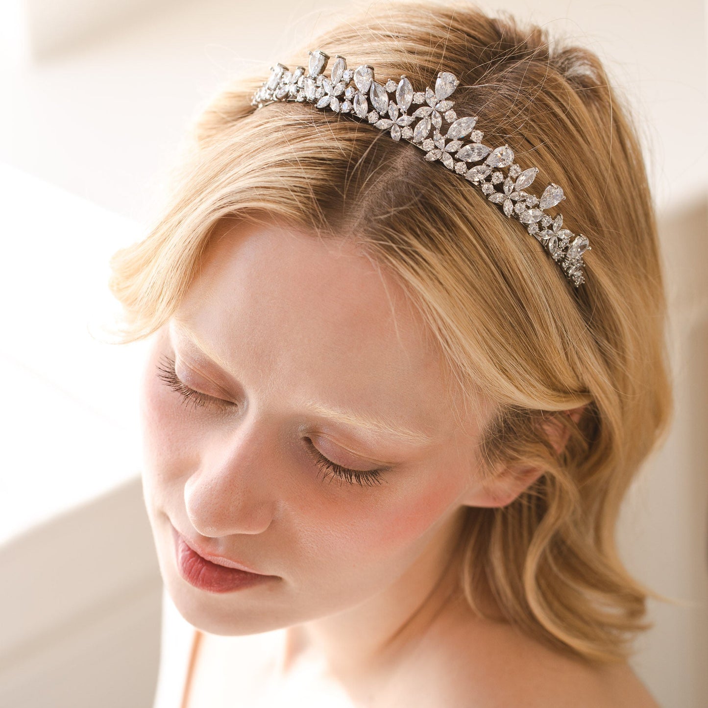 Woman wearing a decorative headband with a neutral background