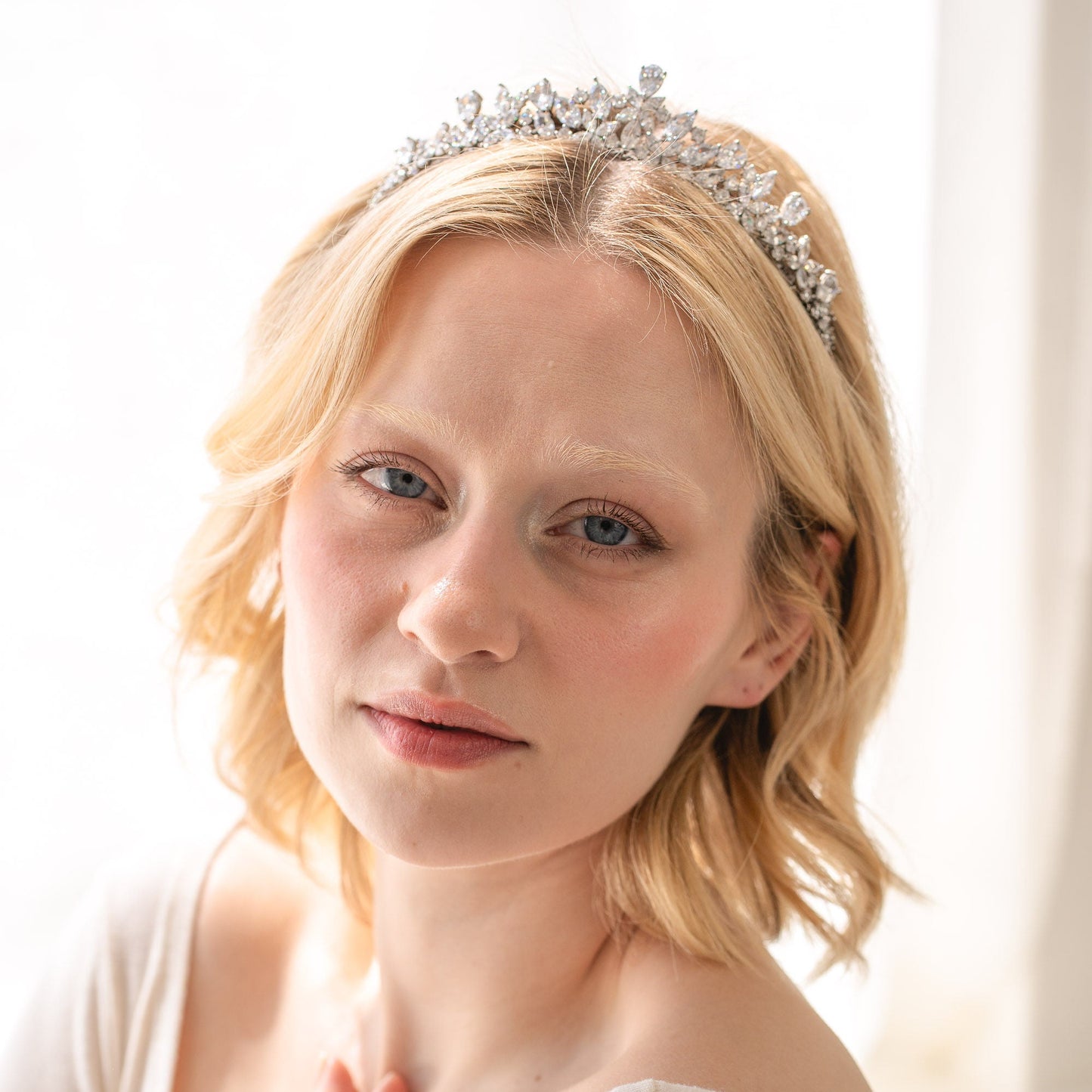 Woman wearing a silver tiara with a soft, blurred background