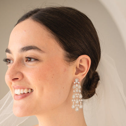 Woman wearing elegant earrings with a soft background