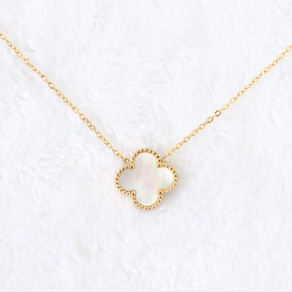 Gold necklace with a heart-shaped pendant on a white background