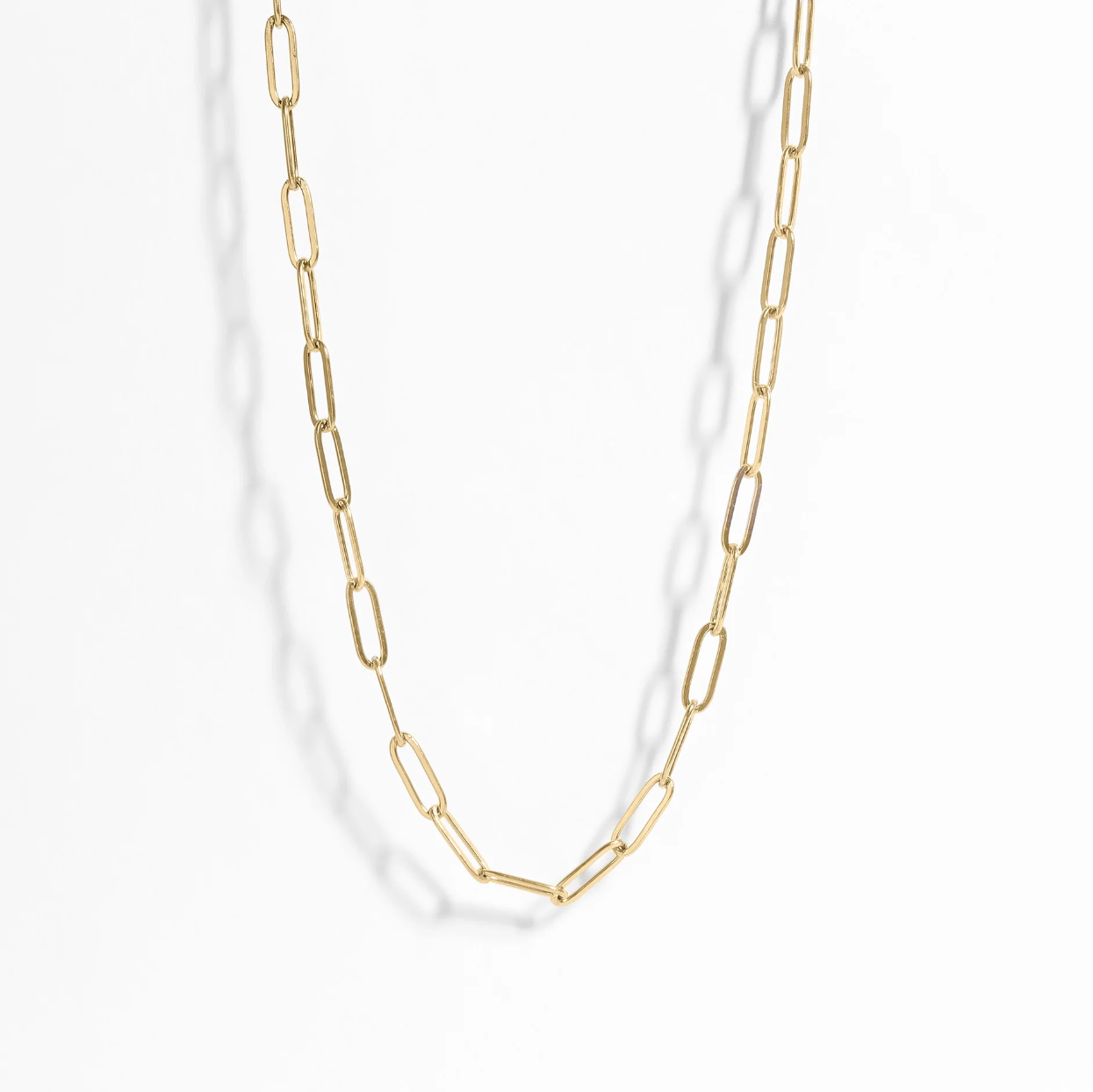 Gold chain necklace on a white background