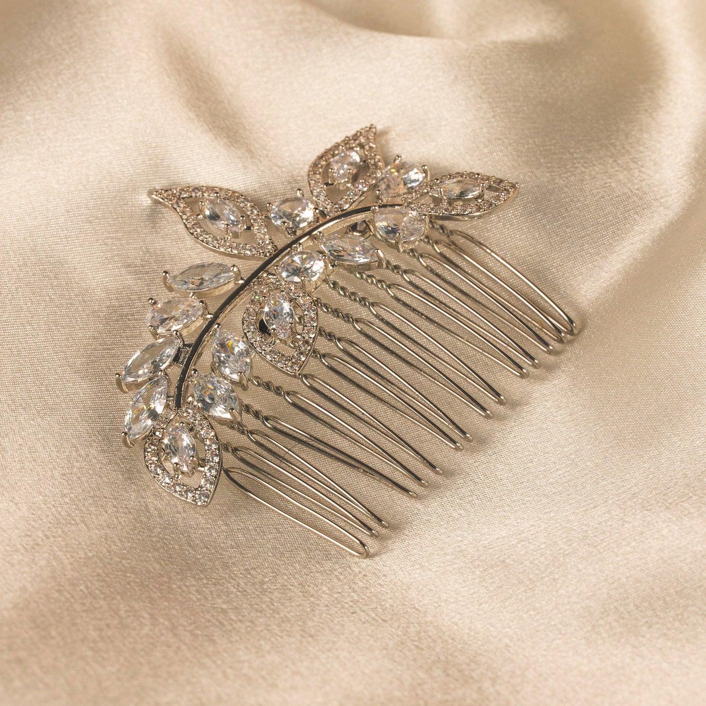 Decorative hair comb with crystals on a satin surface