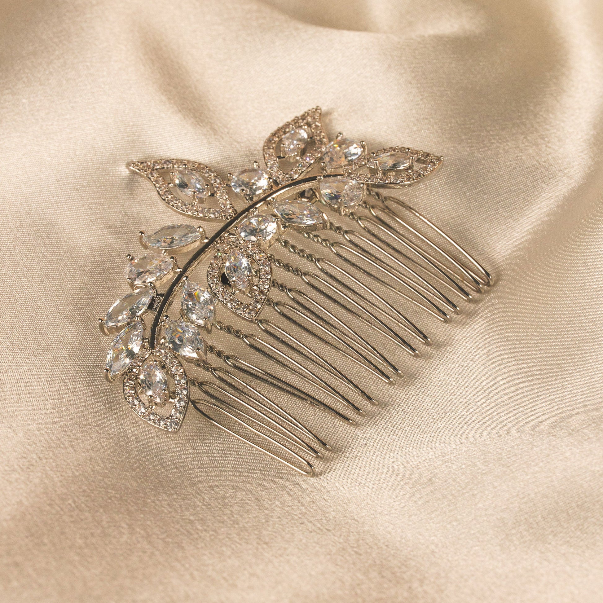 Decorative hair comb with crystals on a satin surface