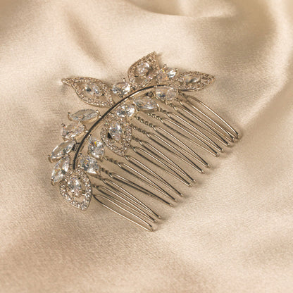 Decorative hair comb with crystals on a satin surface
