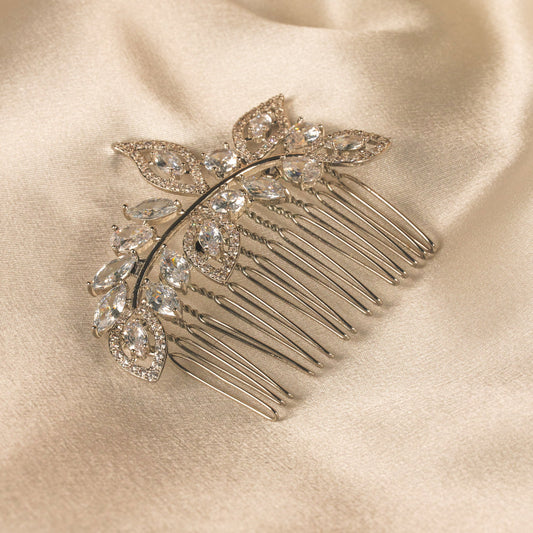 Decorative hair comb with crystals on a satin surface