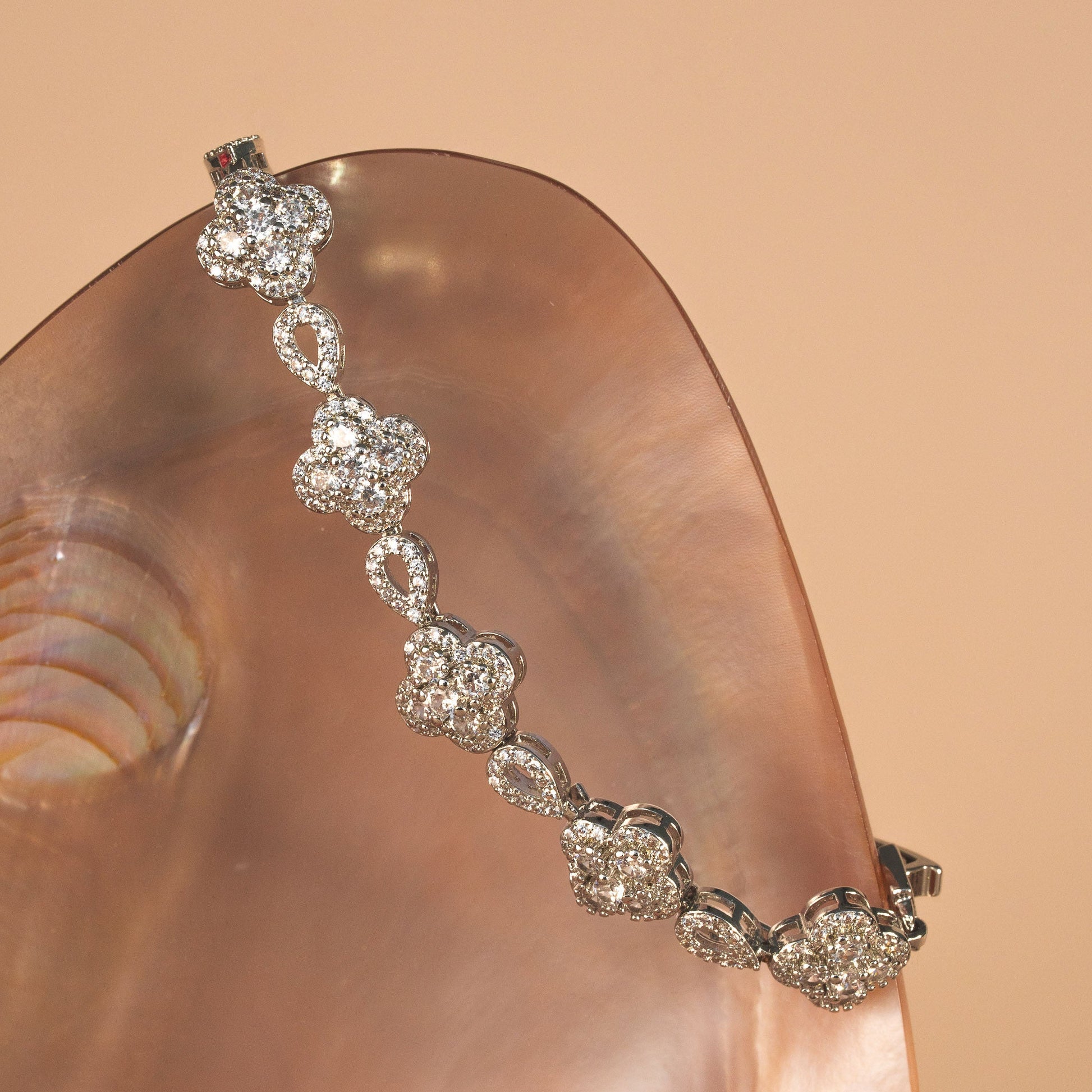 Diamond bracelet on a hand with a beige background
