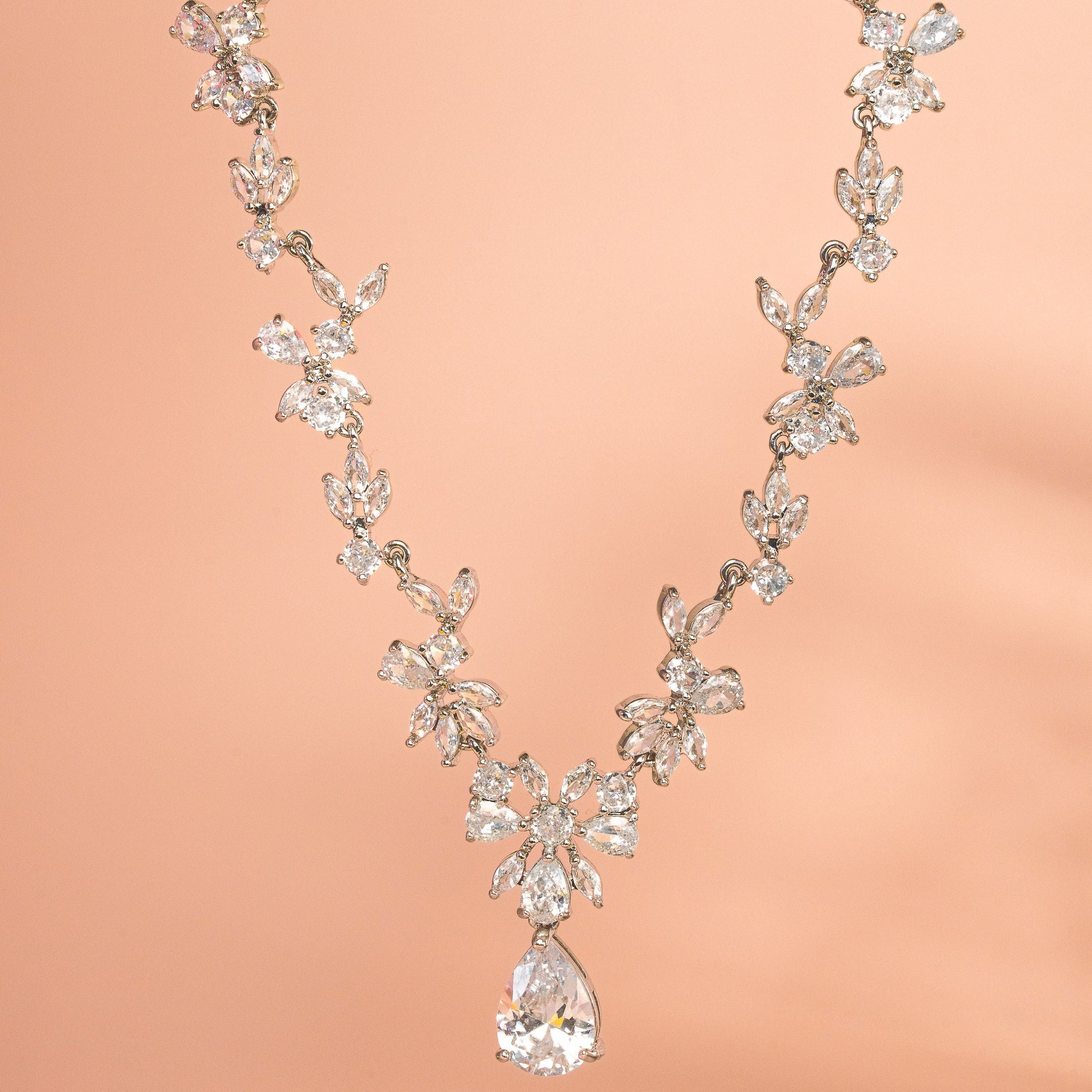 Delicate diamond necklace on a peach background