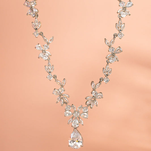 Delicate diamond necklace on a peach background