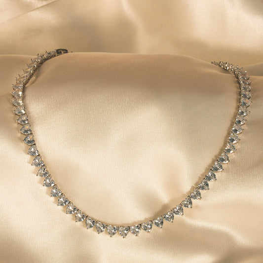 Diamanté necklace on a beige satin background